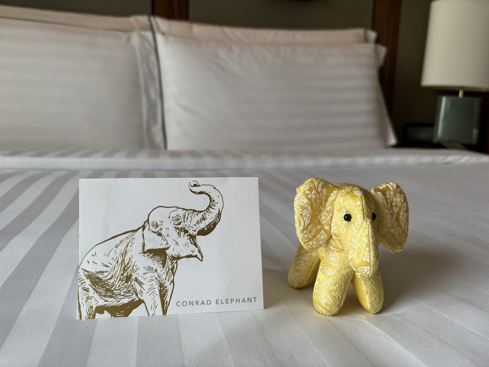Conrad Bangkok welcome elephant and card on bed