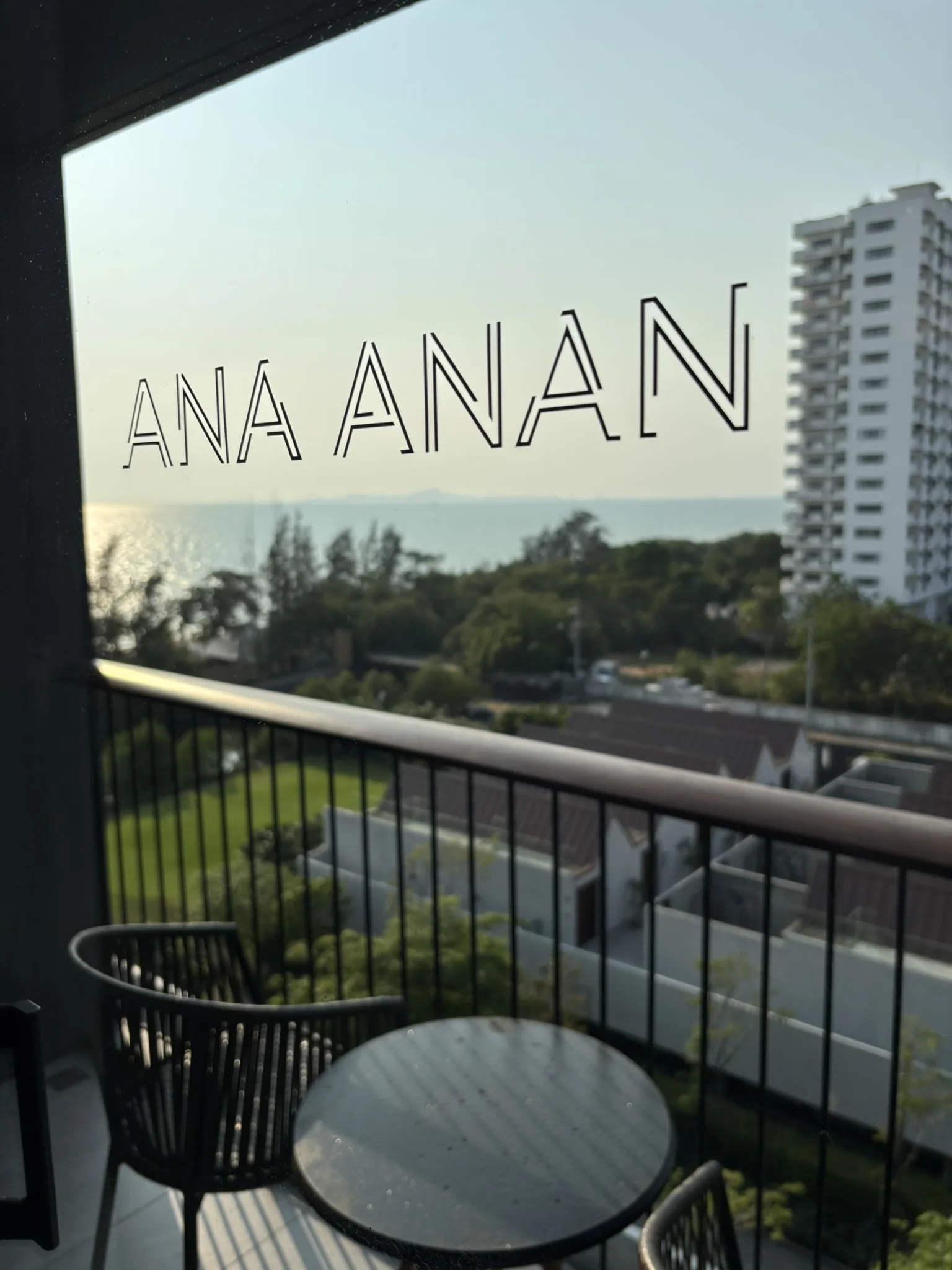 Ana Anan logo on balcony window with sea view