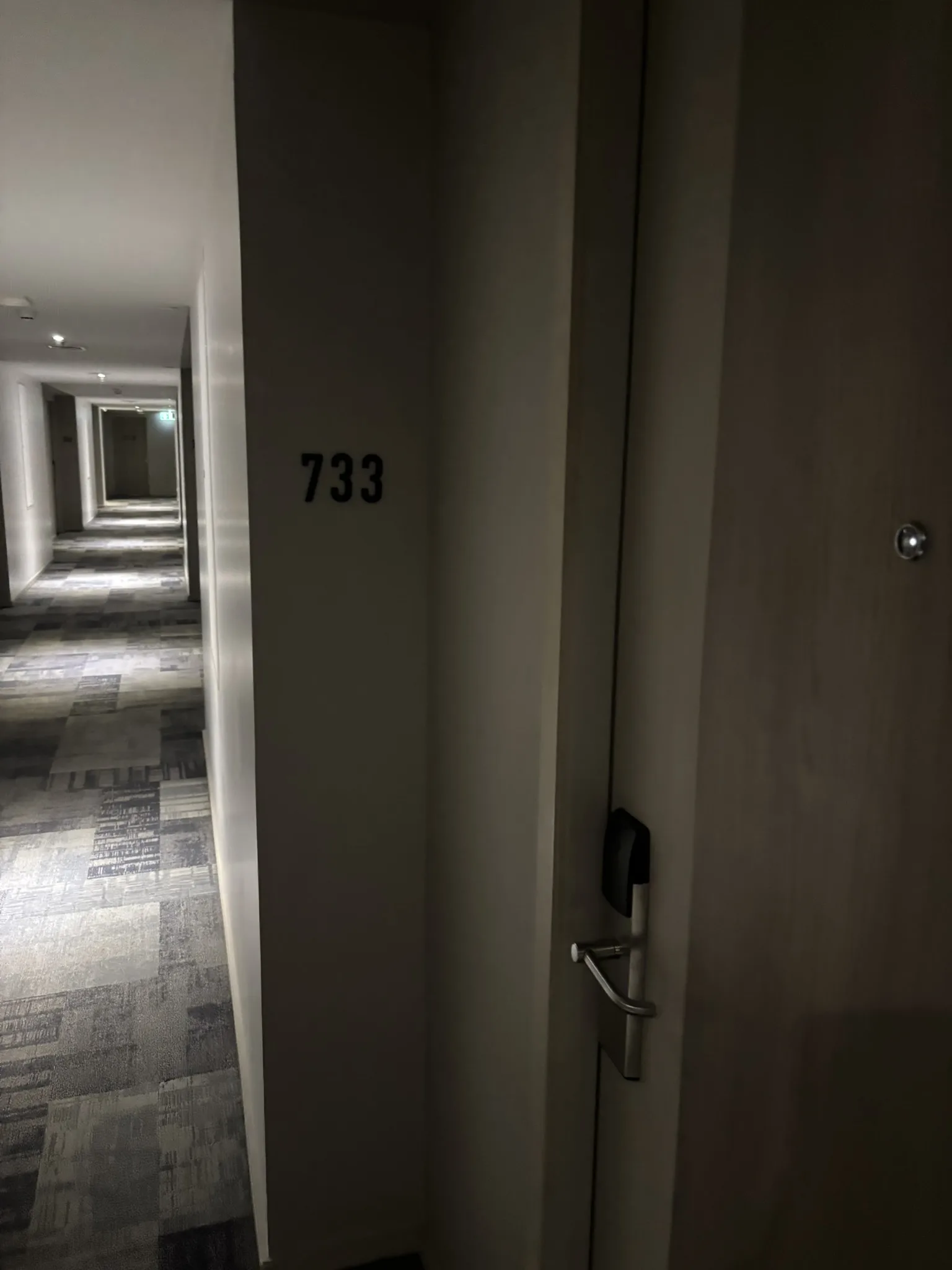 Hotel corridor with patterned carpet and room number door at ASAI Bangkok Chinatown