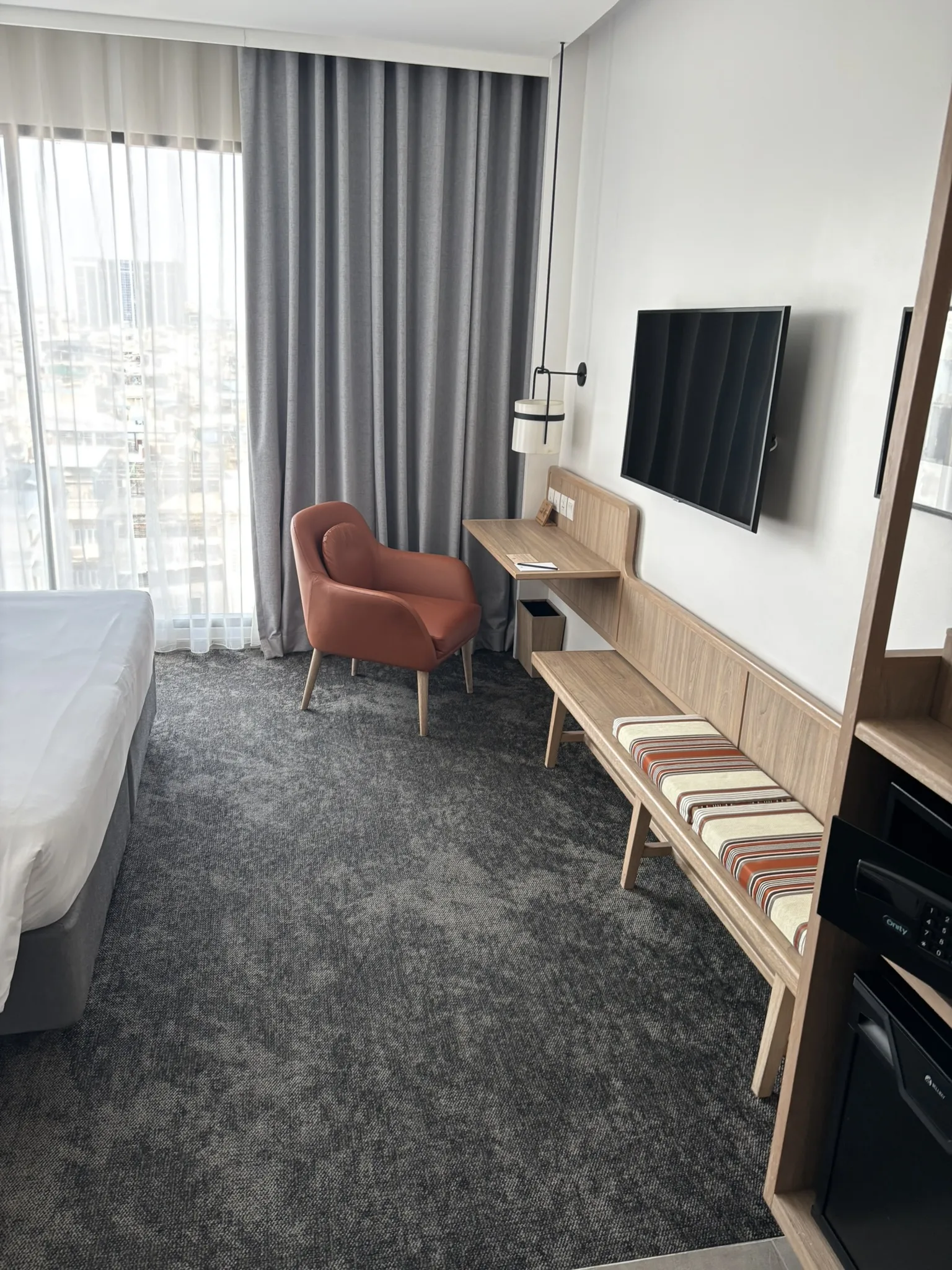 King bed with wooden headboard and white bedding in a guest room at ASAI Bangkok Chinatown