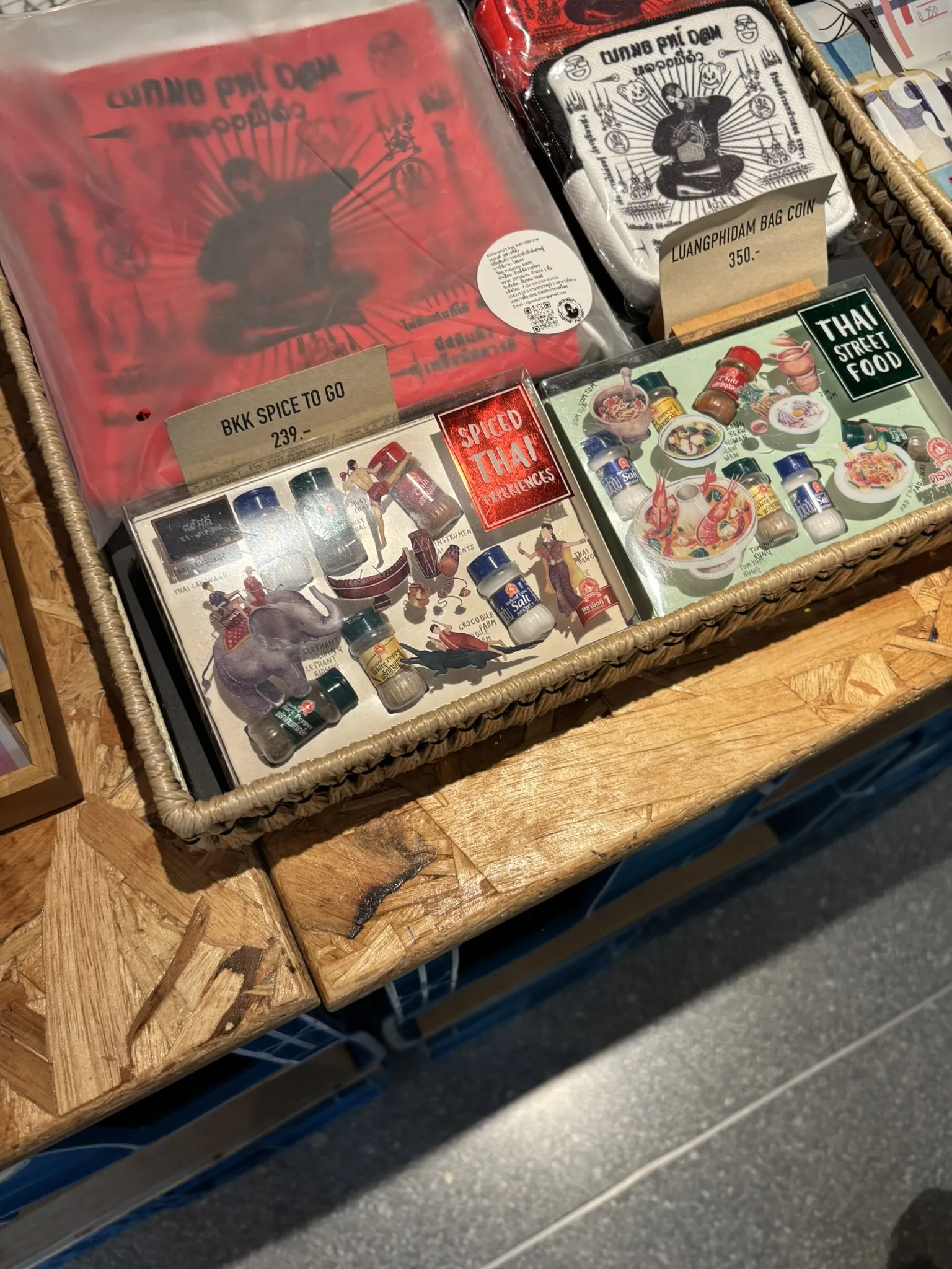 Close-up of Thai spice kits, souvenir books, and street food gift sets for sale at ASAI Bangkok Chinatown