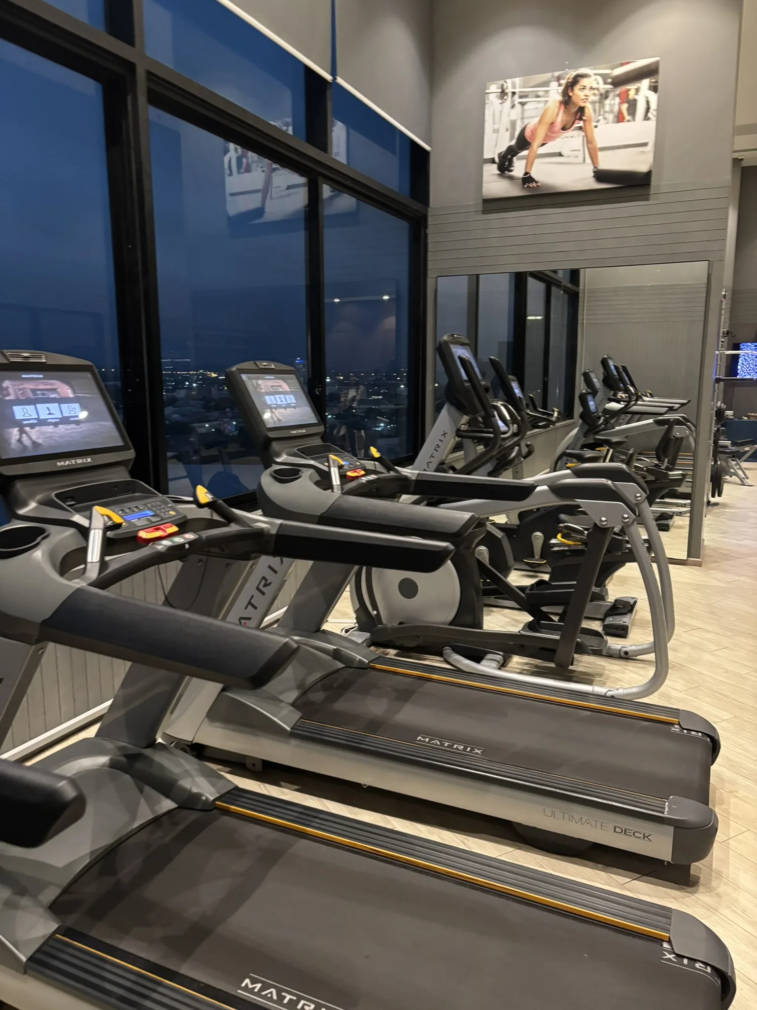 Cardio machines and city view at Brighton Hotel Pattaya gym