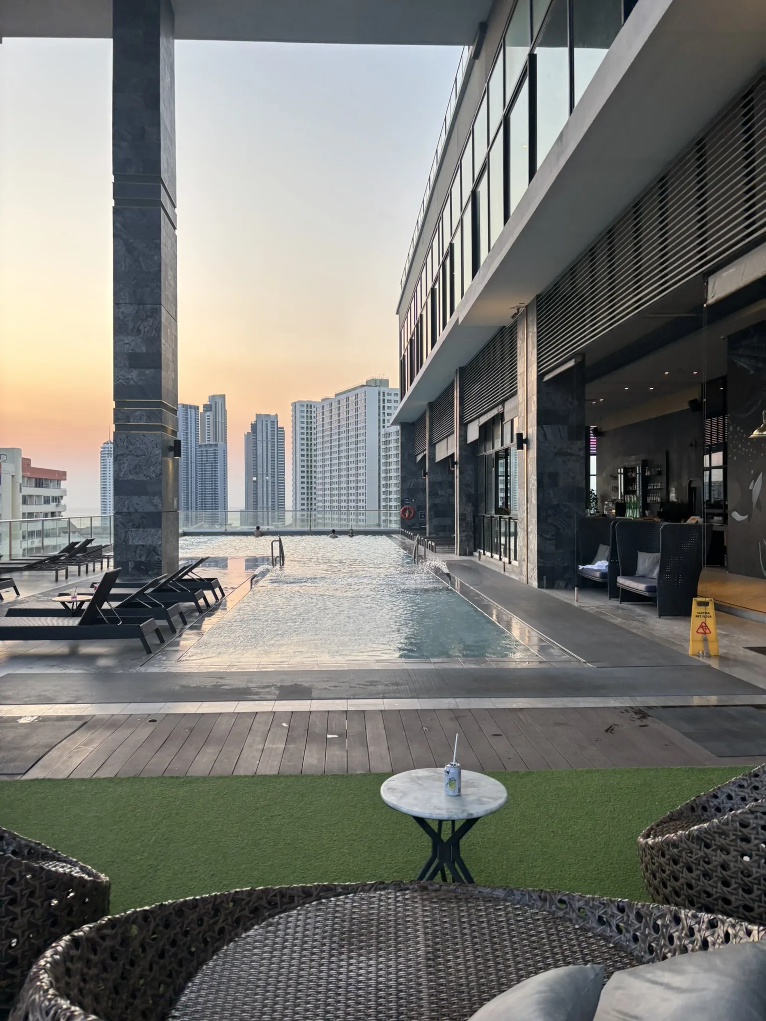 Brighton Hotel Pattaya review - rooftop infinity pool at sunset with city skyline views