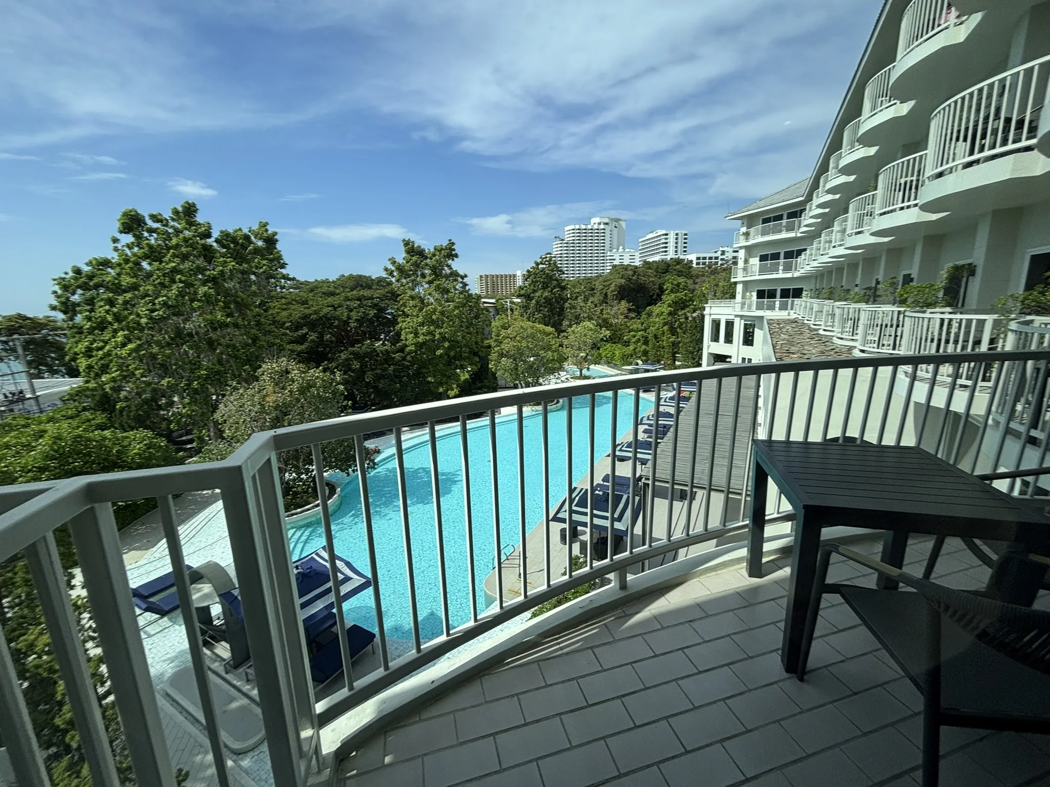 Balcony facing the pool at Cross Pattaya Pratamnak