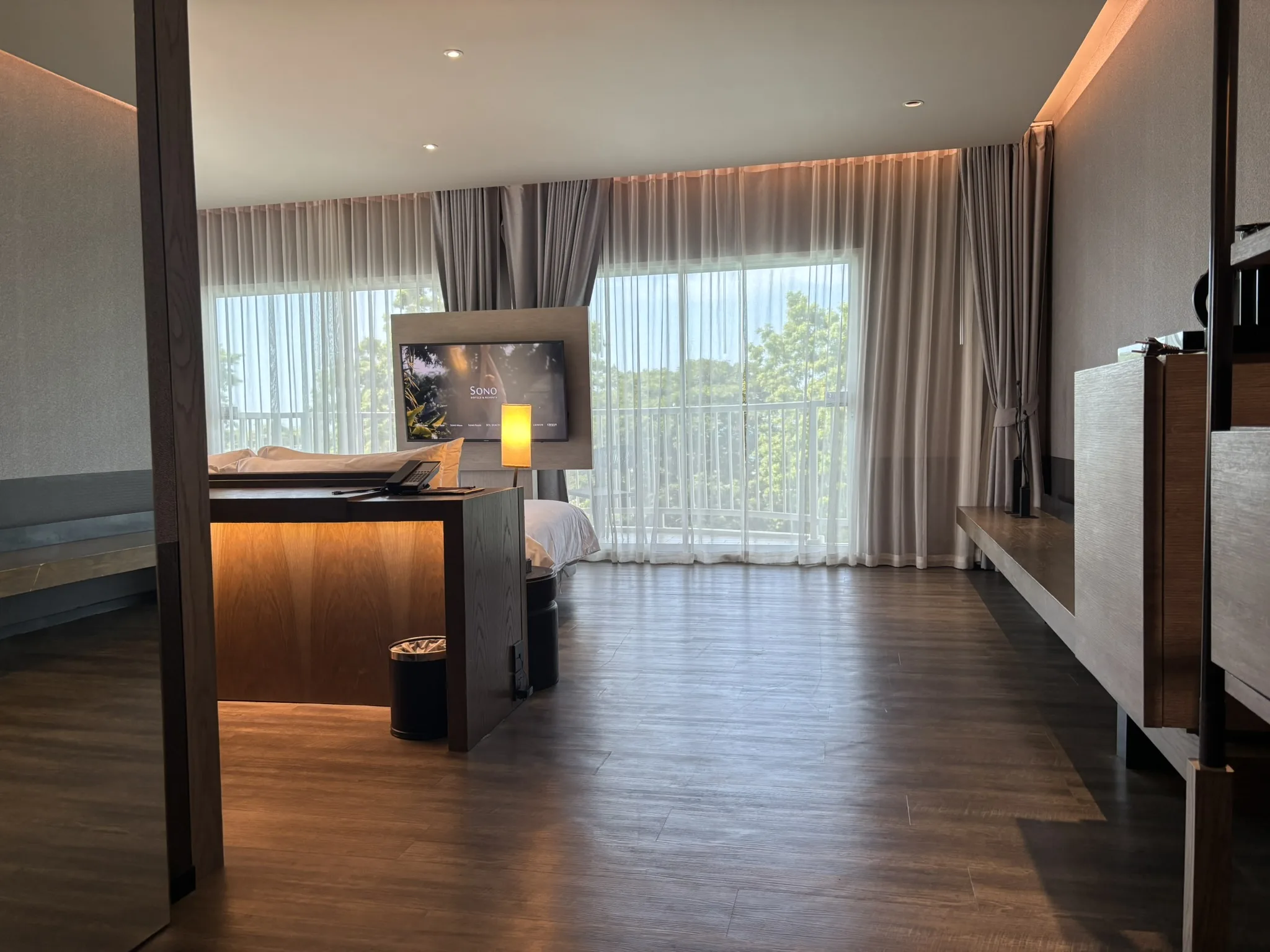Elite Executive Suite with bed facing the pool at Cross Pattaya Pratamnak