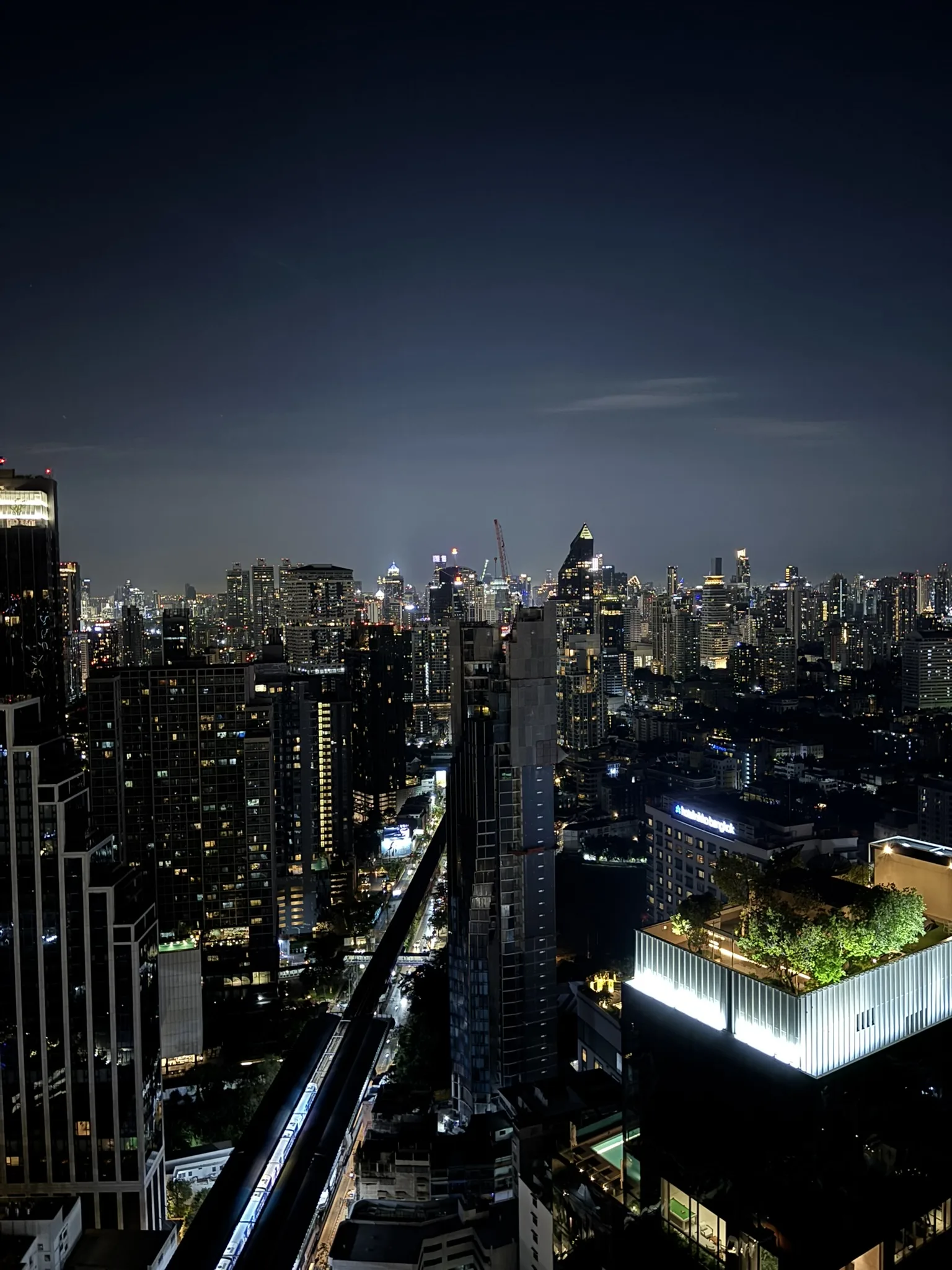 Octave rooftop bar wide Bangkok skyline with BTS line